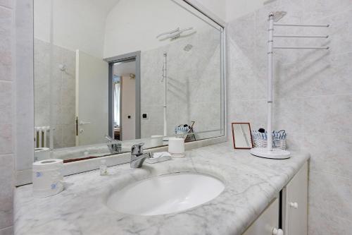 a bathroom with a sink and a large mirror at Terrazza nel Vigneto - Free parking in Tellaro
