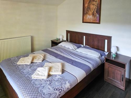 a bedroom with a large bed with two pillows on it at Вила ОРЕХИТЕ in Dupnitsa