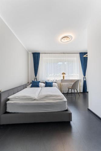 a bedroom with a large bed and a table at Air Linz Residence in Linz