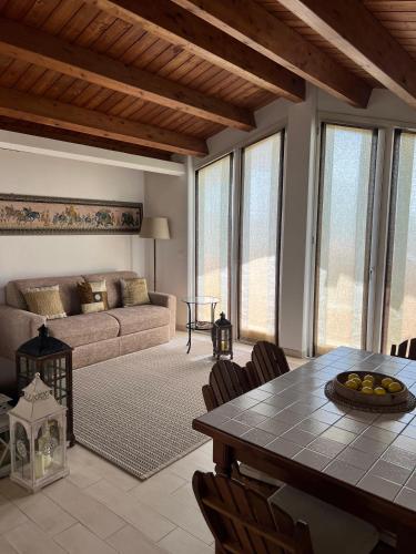 a living room with a table and a couch at I tre platani in Marina di Massa