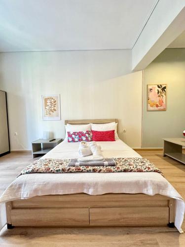 a bedroom with a large bed with two stuffed animals on it at Alpha - City Center Rooms Athens in Athens