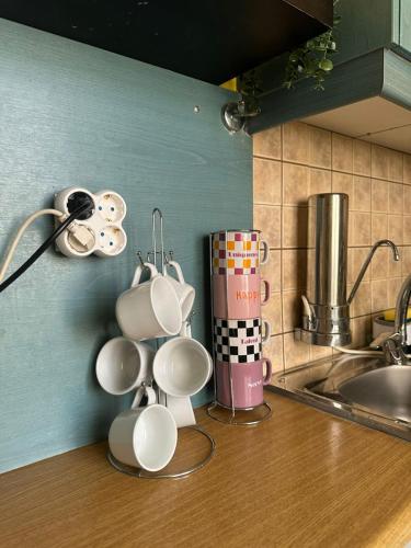 a group of coffee cups on a kitchen counter at Alpha - City Center Rooms Athens in Athens