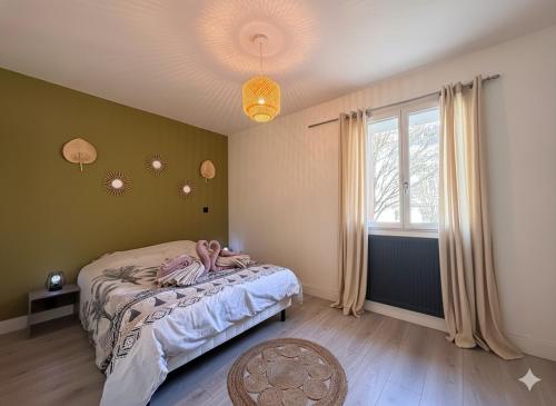 a bedroom with a bed and a window at Le Domi Hyper Centre Proche Cols Stations in Saint-Jean-de-Maurienne