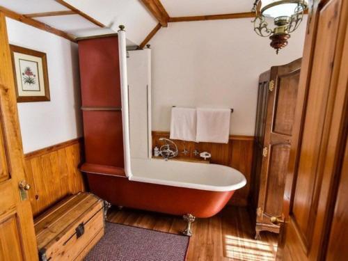 a bathroom with a bath tub in a house at Hobbit Boutique Hotel in Bloemfontein