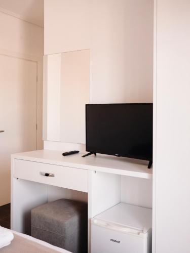 a white desk with a tv on top of it at Hotel Keli in Ksamil