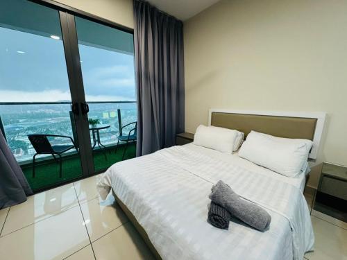 a bedroom with a bed with a view of the ocean at Evo studio soho mini apartment in Bandar Baru Bangi
