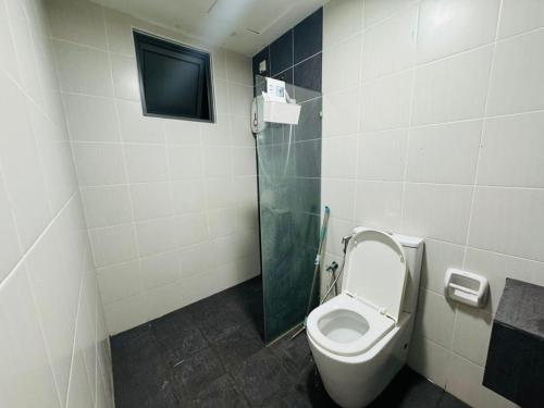 a bathroom with a toilet and a shower and a tv at Evo studio soho mini apartment in Bandar Baru Bangi