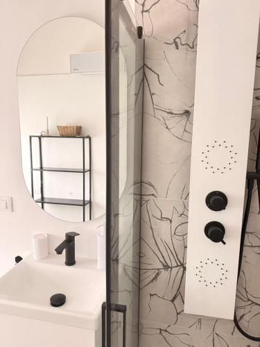 a bathroom with a sink and a shower at Novelli Homes in Formigine