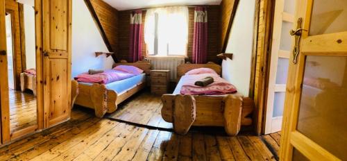 a bedroom with two beds in a room with a window at pension U Jiřího in Ludvíkov