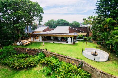 an aerial view of a house with a yard at SeaWaves Beach House, Shelly Beach in Shelly Beach