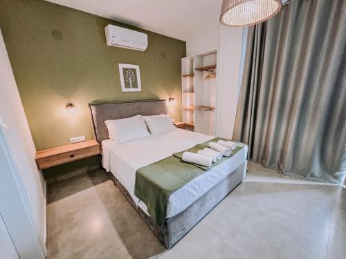 a bedroom with a bed with two towels on it at Meraki Nikiti in Nikiti