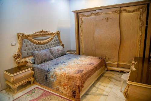 a bedroom with a bed with an ornate headboard at New Villa Carimo in Quseir