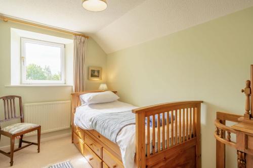 a bedroom with a bed and a window and a crib at 3 Bed in Coldstream oc-c39085 in Coldstream
