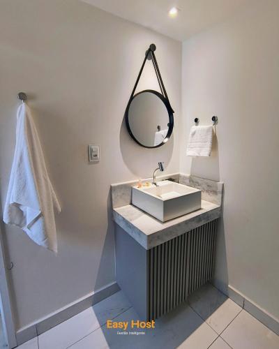 a bathroom with a sink and a mirror at Flats Unity Cabo Branco - By EasyHost in João Pessoa