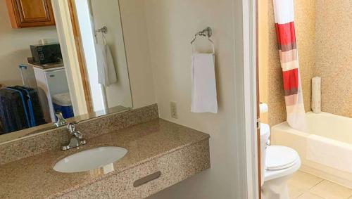 a bathroom with a sink and a toilet at Relax Inn Bloomsburg in Bloomsburg