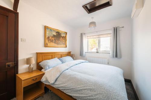 a bedroom with a bed and a window at 2 Bed in Thurleigh oc-o42689 in Thurleigh