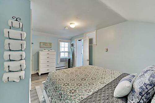 a bedroom with a bed and a white dresser at Old Orchard Cottage in Old Orchard Beach