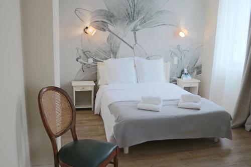 a bedroom with a bed with two towels on it at Les Ambassadeurs hôtel 3 Etoiles nouvelles chambres 2026 logis hôtel in Souillac