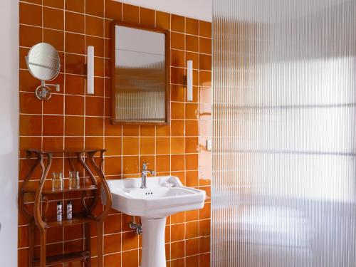 a bathroom with a sink and a mirror at Hôtel La Figuière in Saint-Tropez