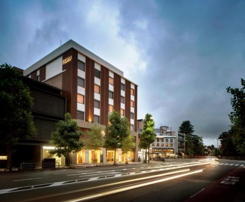 a building on the side of a street with a road at Noku Kyoto in Kyoto