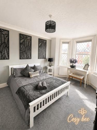 a bedroom with a large white bed in a room at Cosy Bee in Bournemouth