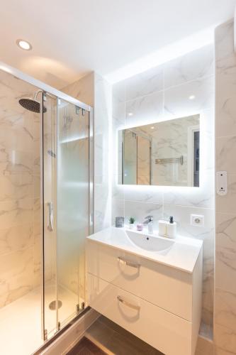 a bathroom with a sink and a shower at Parking free - cosy & elegant in LʼHay-les-Roses