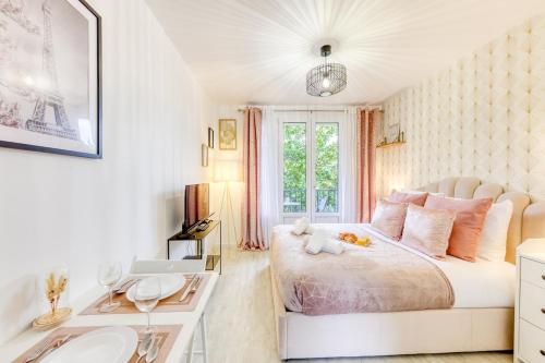 a white bedroom with a bed and a sink at Parking free - cosy & elegant in LʼHay-les-Roses