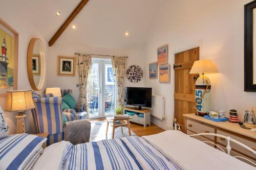 a bedroom with a bed and a desk and a television at Finest Retreats - The Rectory Nook Annexe in Saint Teath