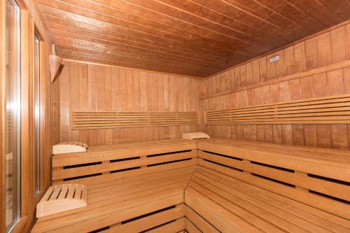 a sauna with wooden paneling and two benches at Trafalgar 231 in Döse