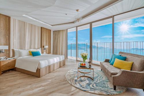 a hotel room with a bed and a couch at The Atier Gem Suites in Nha Trang
