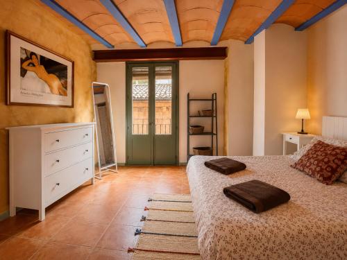 a bedroom with a bed and a window and a door at Apartamentos Saltarel·lo in Besalú