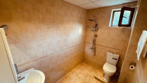 a bathroom with a toilet and a sink at EGGO APARTMENT - Oasis Beach Apartments Kamchia in Dolen Bliznak