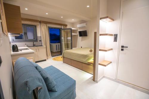 a bedroom with a bed and a couch in a room at Themelina Studios in Emborios