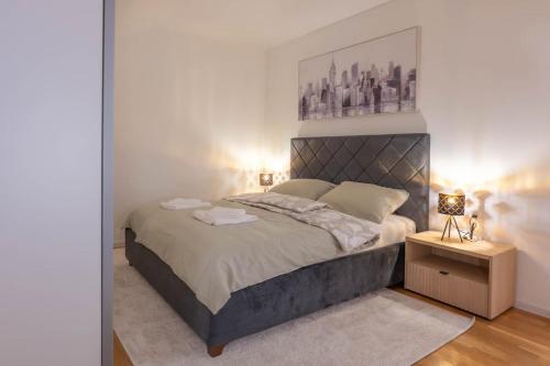 a bedroom with a large bed and a night stand at Aurea Lika - Gospic in Gospić