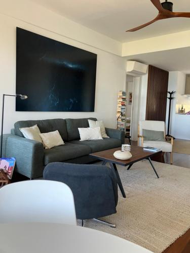 a living room with a couch and a table at Oceanview 4 U - Close to Lisbon! in Oeiras