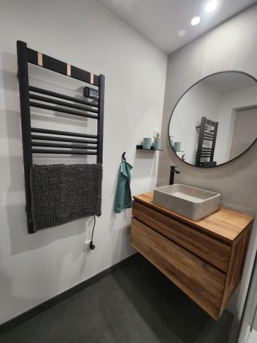 a bathroom with a sink and a mirror at Une escapade en Provence in Pertuis