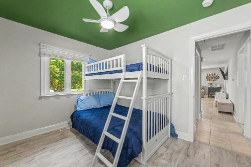a bedroom with a bunk bed and a ceiling fan at Shore Escape Steps to the Beach in Ventnor City