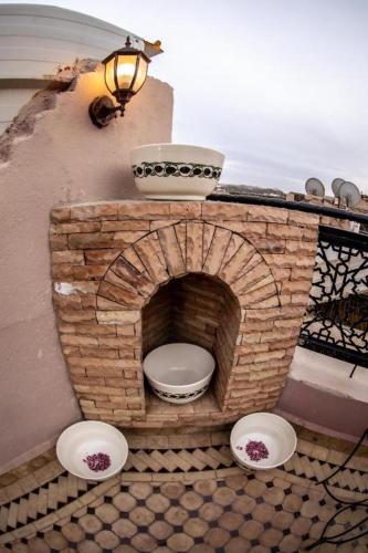 a brick toilet in a brick oven with bowls on it at Dar al haja rahma in Fez
