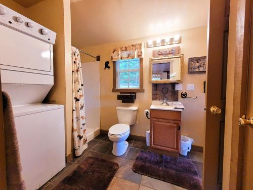 a small bathroom with a toilet and a sink at FireFly Acres in Sparta
