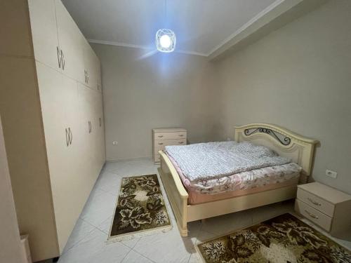 a bedroom with a bed and a dresser in it at Flag's Square House Vlore in Vlorë