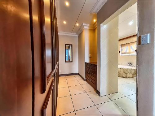 a hallway with a bathroom with a sink at Gracelands Beach Lodge in Ramsgate