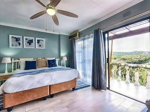 a bedroom with a bed and a large window at Gracelands Beach Lodge in Ramsgate