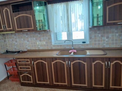 a kitchen counter with a sink and a window at Studios Florand Sela Ksamil in Ksamil