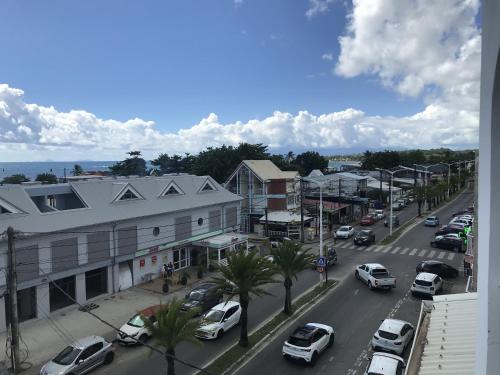 a city street with cars parked on the street at Résidence Le Lagon in Sainte-Anne
