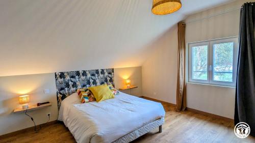 a bedroom with a large bed and a window at Clos de Vellerot in Saint-Pierre-en-Vaux