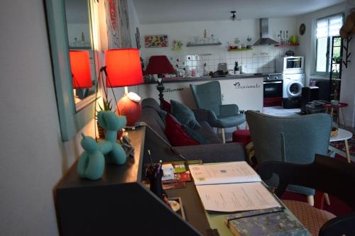 a living room with a couch and a table at Gite le GINKGO 50 M2 in Rougegoutte