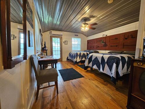 a bedroom with two beds and a table in it at FireFly Acres in Sparta