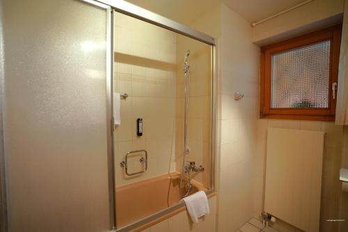 a bathroom with a shower with a glass door at Chalet Miravalle 1 in Wengen