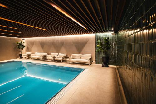 a swimming pool in a room with chairs at St Elisabeth in Tromsø