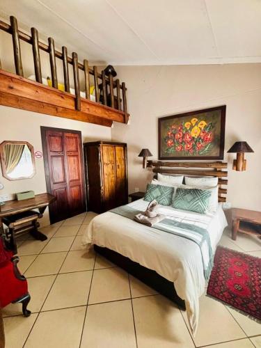 a bedroom with a bed with a cat laying on it at Adem Gasteplaas & Function Venue in Kroondal